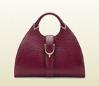 Stirrup raspberry ostrich top handle bag